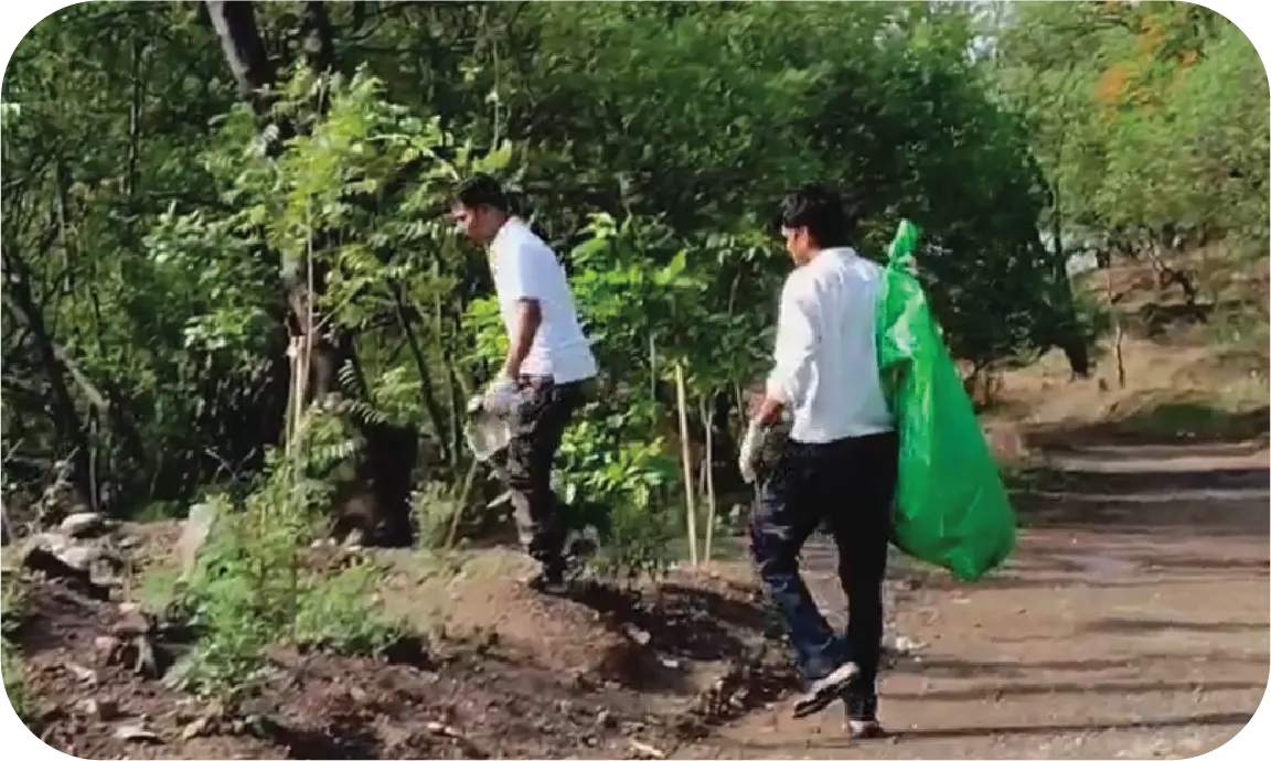Volunteers walking through a wooded area during a cleanup drive